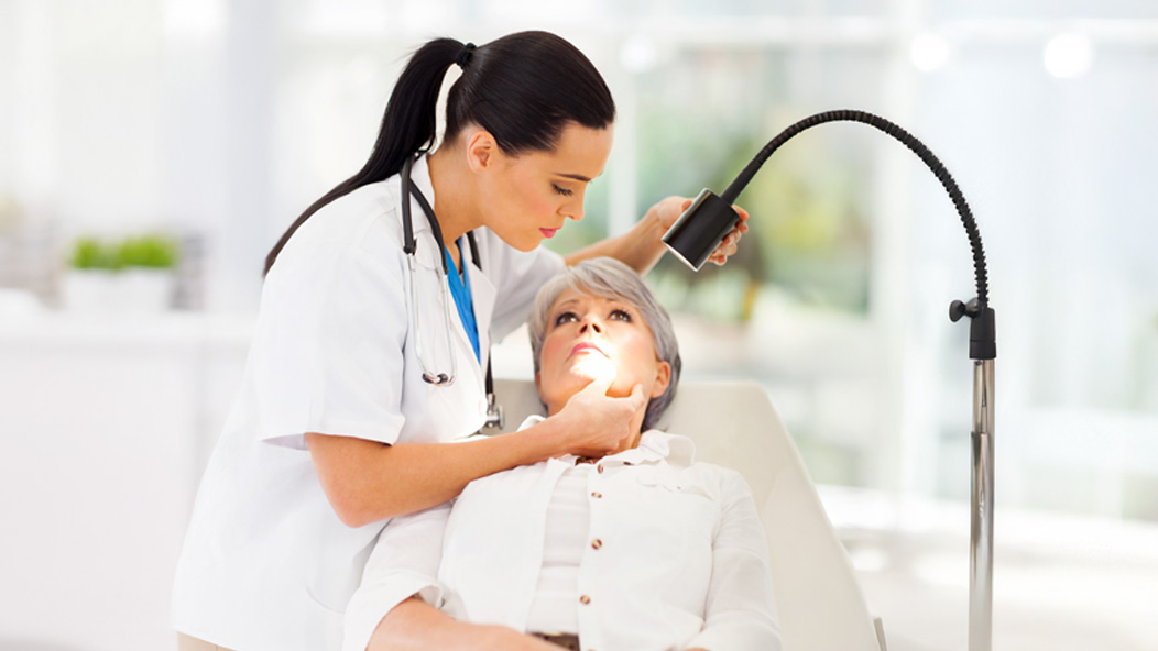 Dermatologist treating patient 