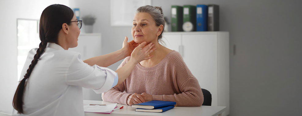 Physician checking the lymph nodes of female patient