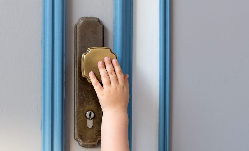 Child Touching a Door Knob