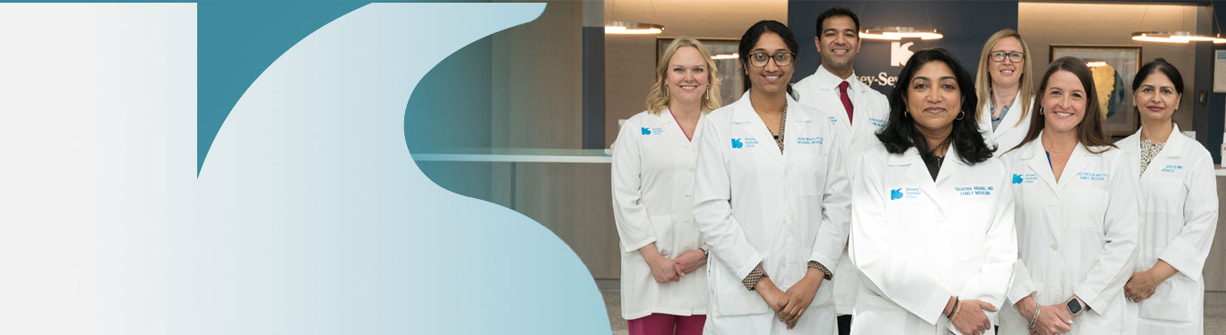 Kelsey-Seybold physicians posing confidently inside a clinic foyer