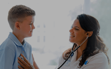 Kelsey-Seybold doctor checking young patient