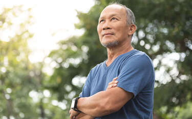 A man stands outside in the sun.