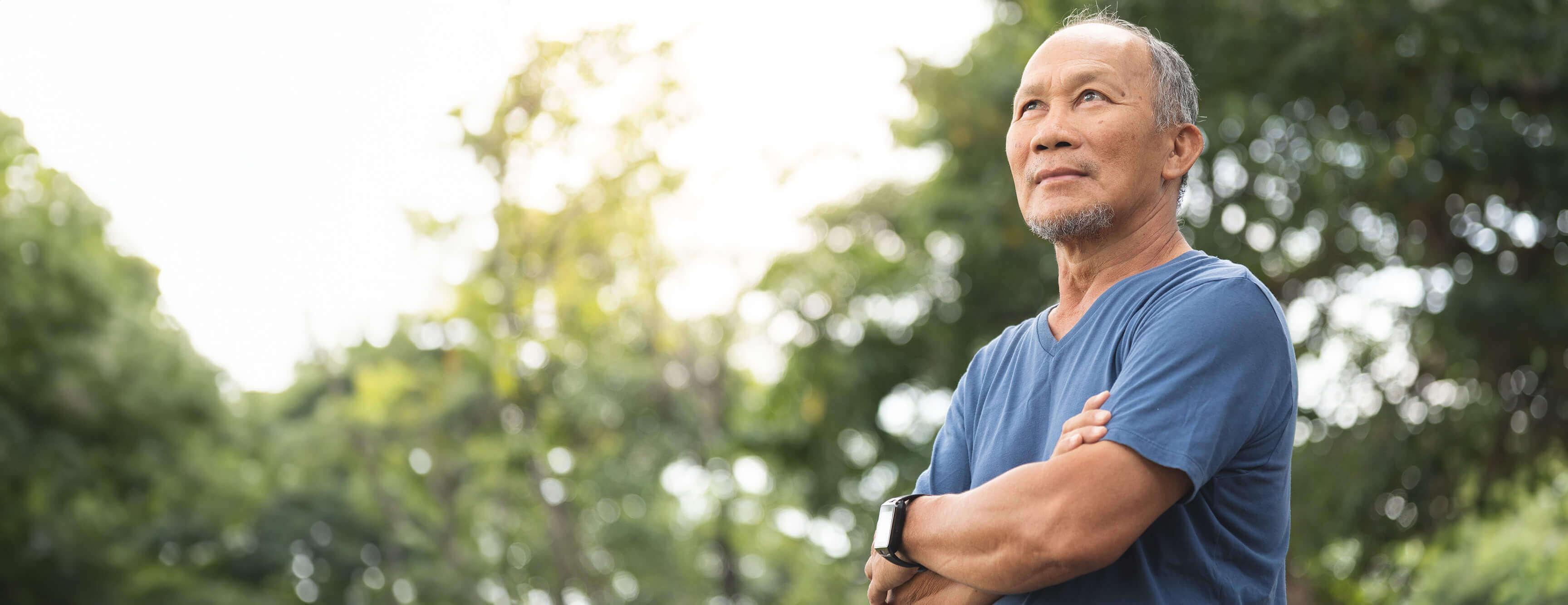 A man stands outside in the sun.
