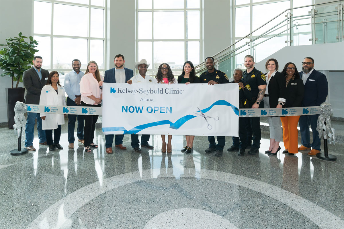 Kelsey Seybold Team cutting Aliana clinic Ribbon