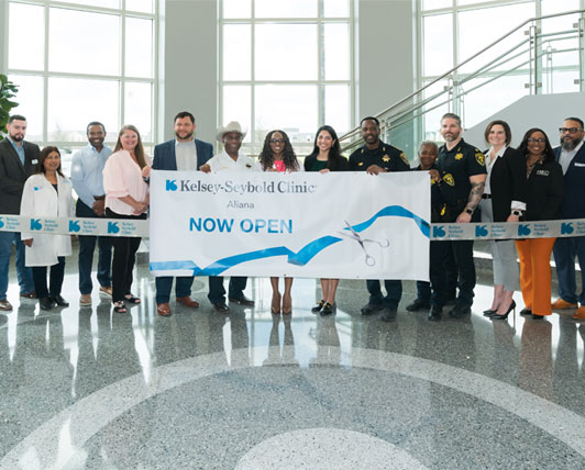 Kelsey Seybold Team cutting Aliana clinic Ribbon