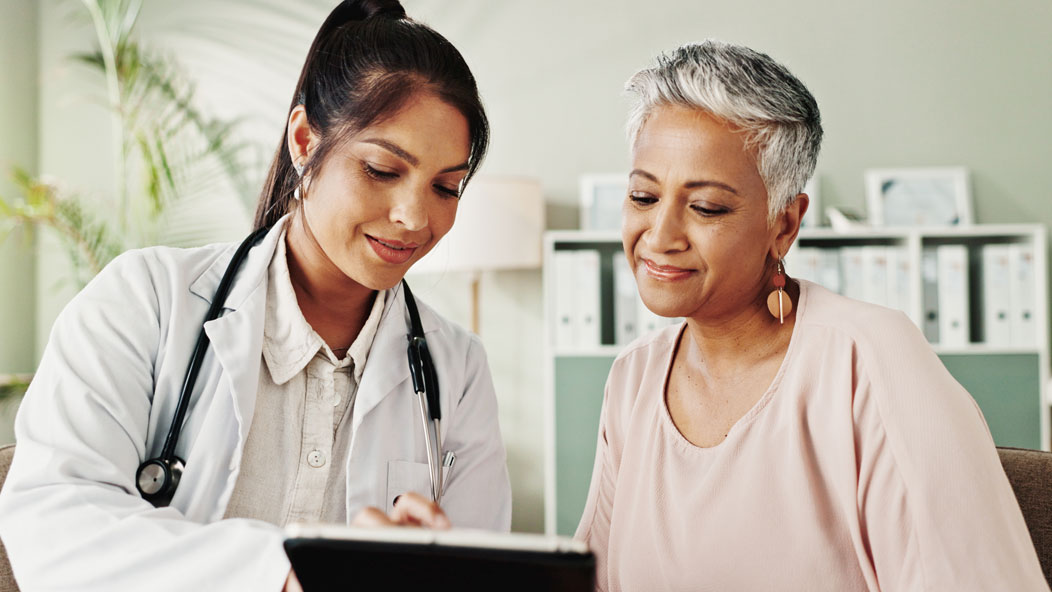Doctor showing chart to senior patient