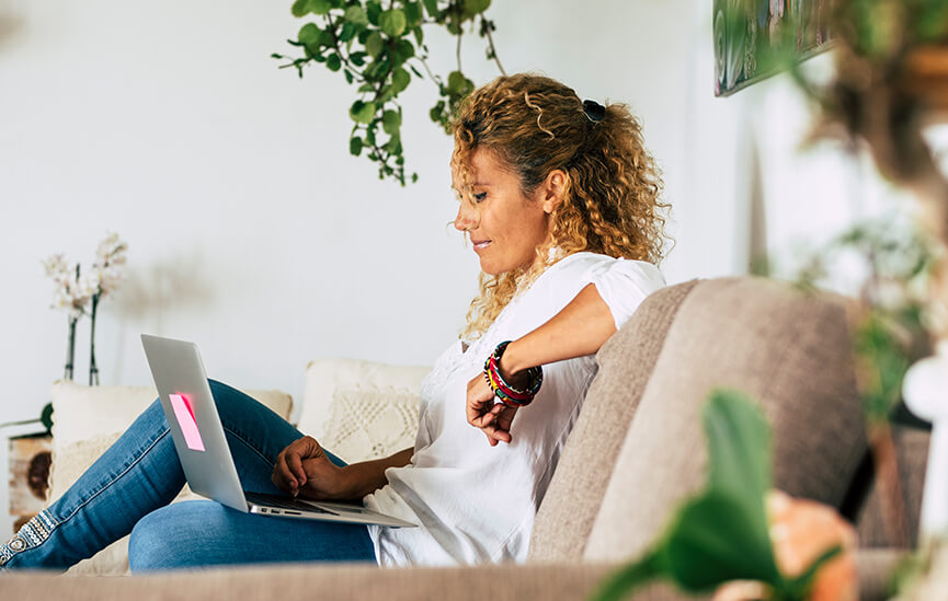 Woman relaxing at home with a laptop